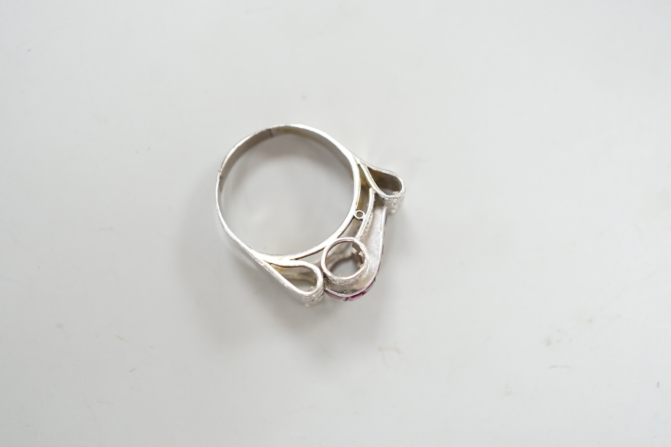 A 1950's? white metal, graduated ruby and diamond cluster set cocktail ring, size Q, gross weight 9.1 grams.